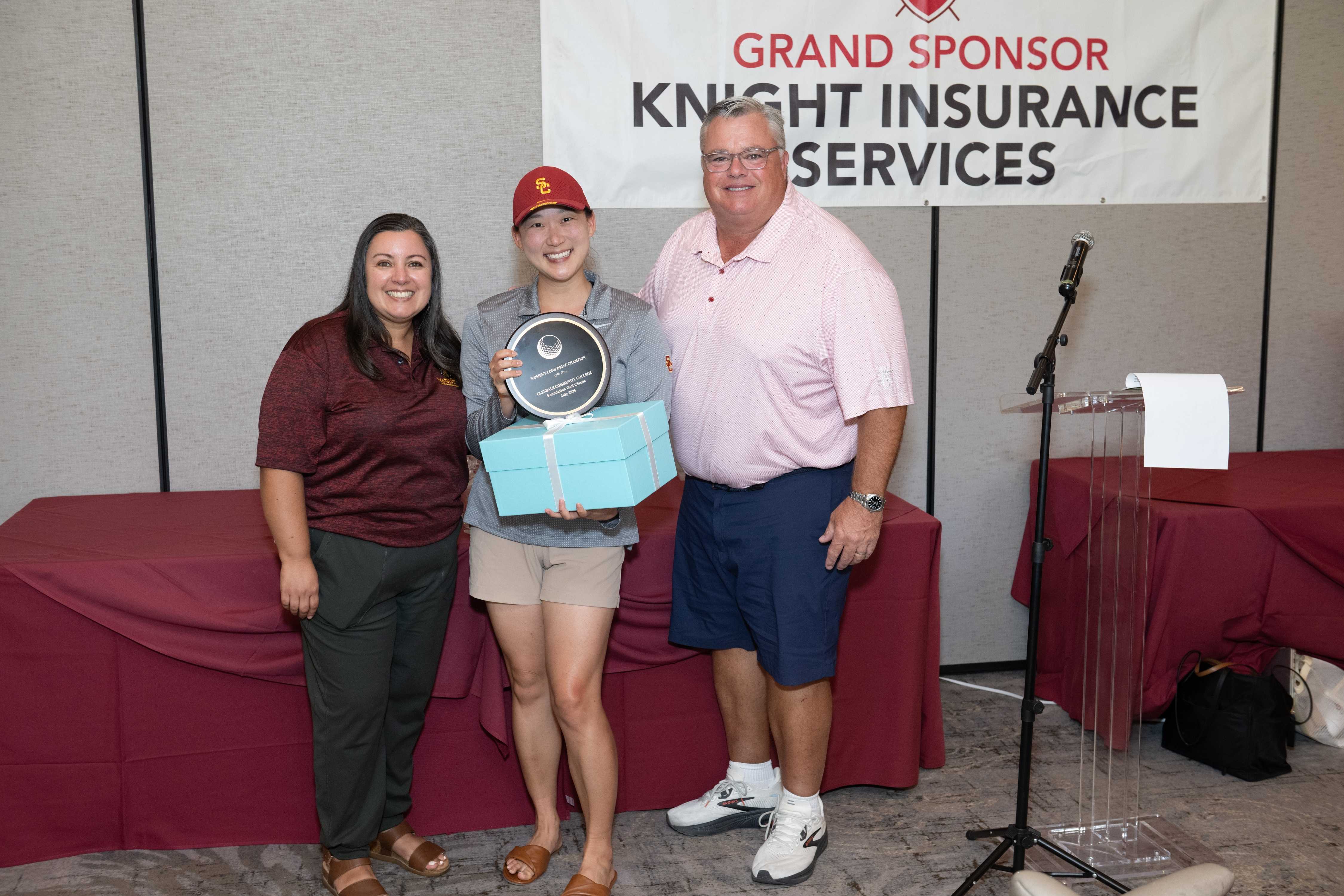 Paola Santana and Rick Dinger presents the Women's Long Drive Award to Grace Won. This is Grace's fourth consecutive win.