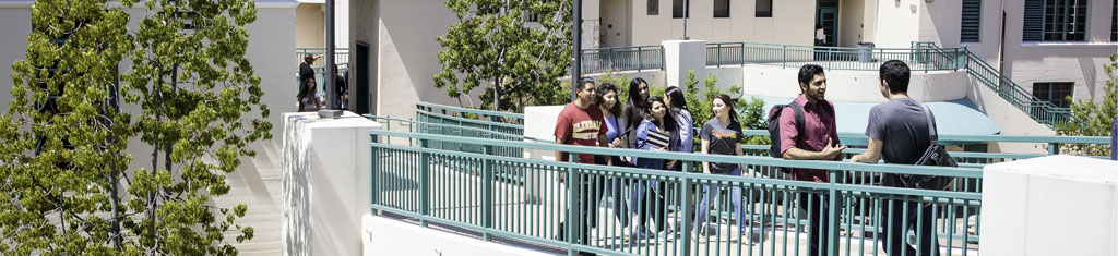 Students standing on bridge over SG plaza