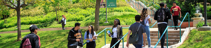 Students walking by fountain