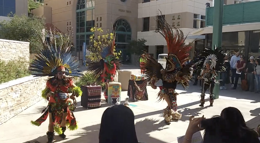 Three Aztec Dancers dancing at the GCC campus in celebration of Dia de los Muertos