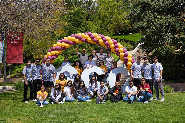 GCC students and staff posing in front of giant GCC letters in Plaza Vaquero