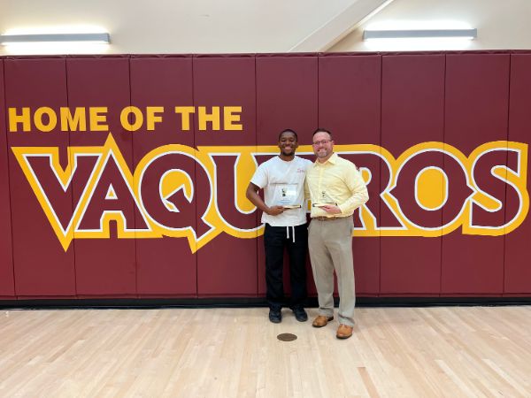 Men’s Tennis Player, JB Badon standing next to Dr. Cornner